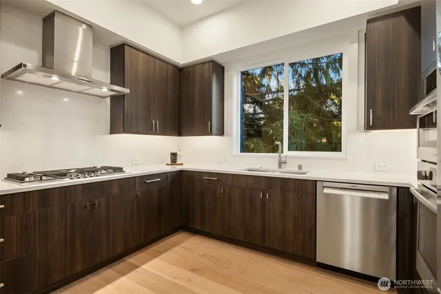 a kitchen with stainless steel appliances granite countertop a refrigerator and a sink