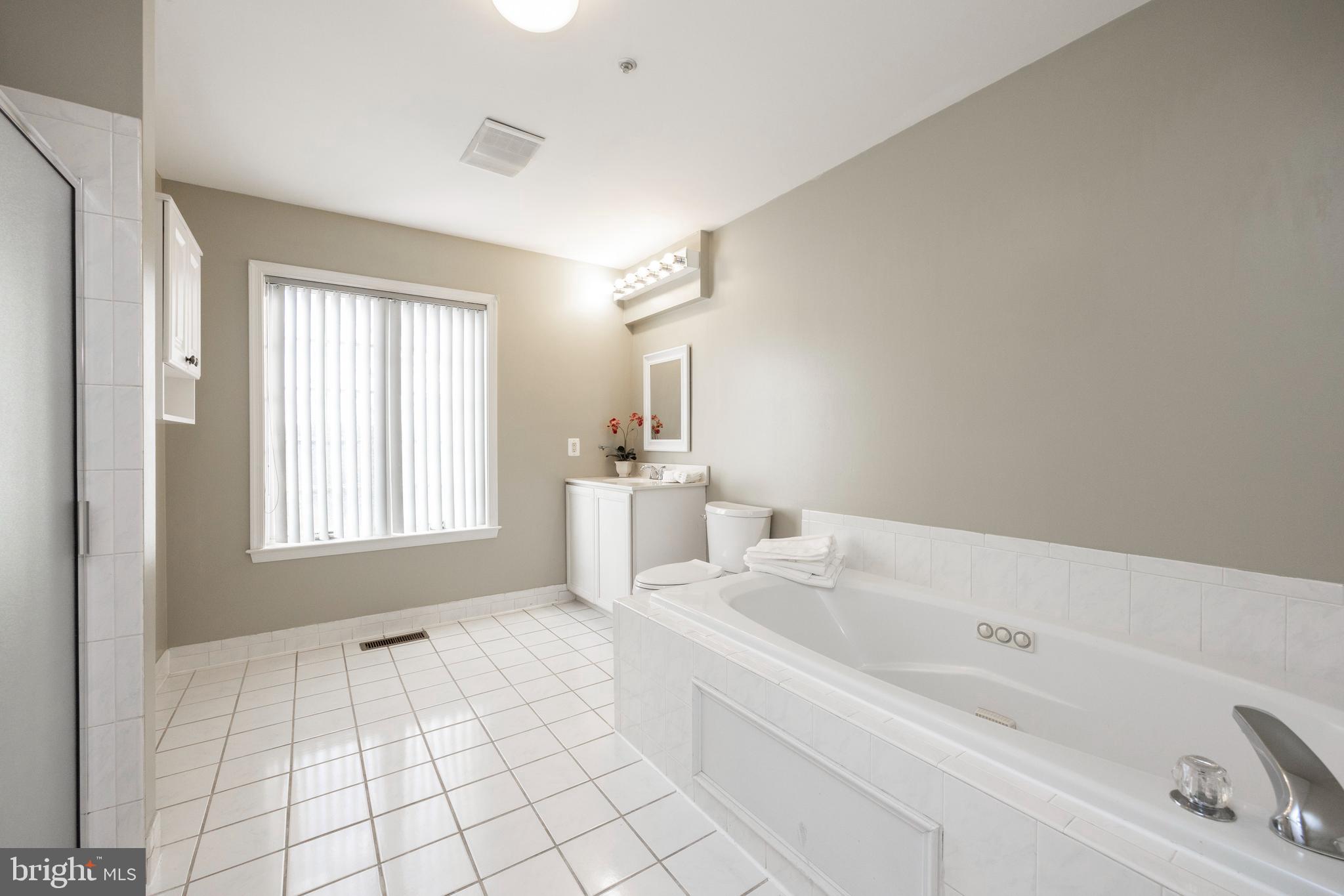 521 Pewter Drive Exton, PA 19341 - Photo 26 of 52 a bathroom with a bathtub sink vanity and mirror