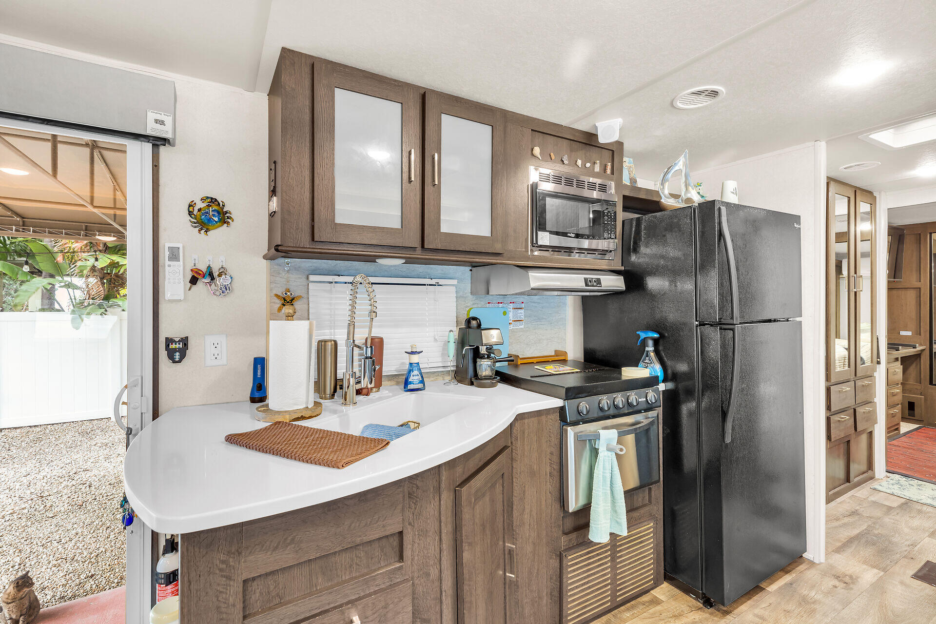 325 Calusa Street, Unit 70 Key Largo, FL 33037 - Photo 9 of 32 a kitchen with stainless steel appliances a sink a stove a refrigerator cabinets and a dining table