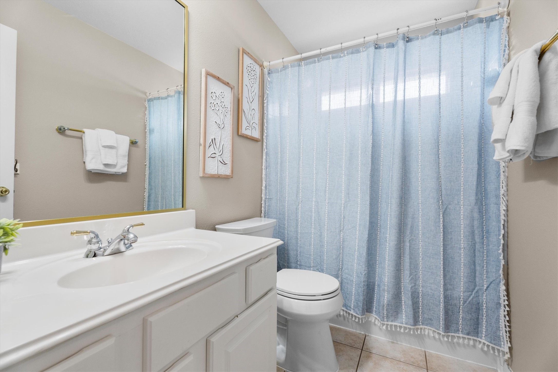 6323 Stone Trail Lane Spring, TX 77379 - Photo 26 of 43 a bathroom with a sink a toilet and shower curtain