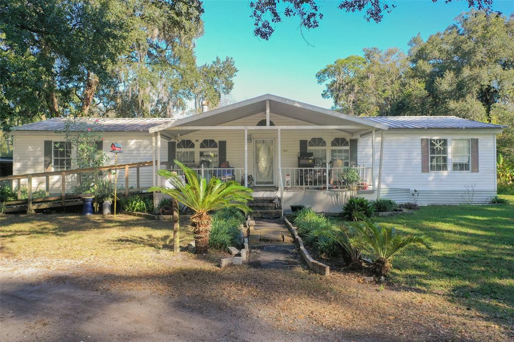5013 Greenbriar Road Lakeland, FL 33810 - Photo 1 of 34 a front view of house with yard outdoor seating and green space