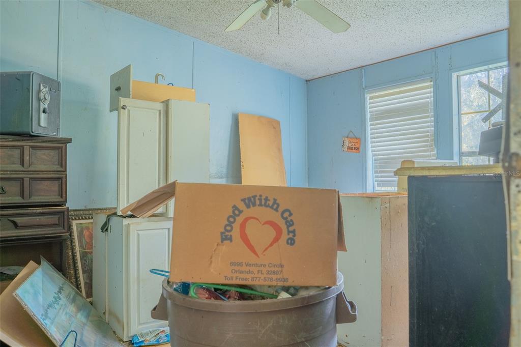 5013 Greenbriar Road Lakeland, FL 33810 - Photo 25 of 34 a room with water heater and wooden cabinets