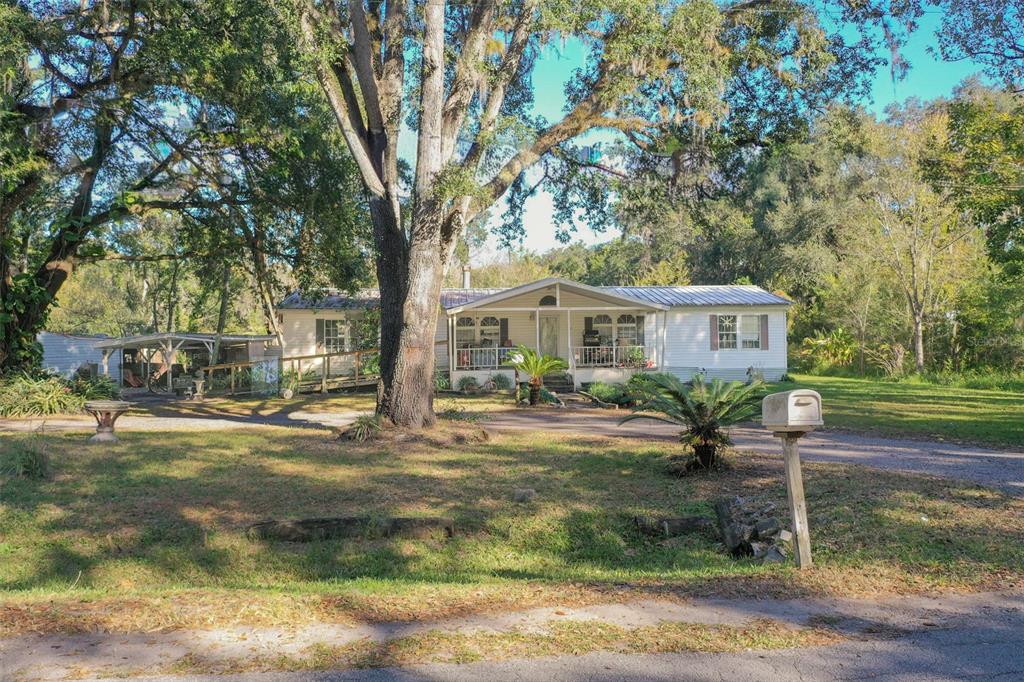 5013 Greenbriar Road Lakeland, FL 33810 - Photo 9 of 34 a front view of a house with garden