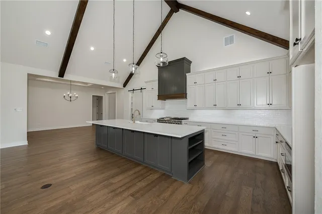 a kitchen with a sink cabinets and wooden floor