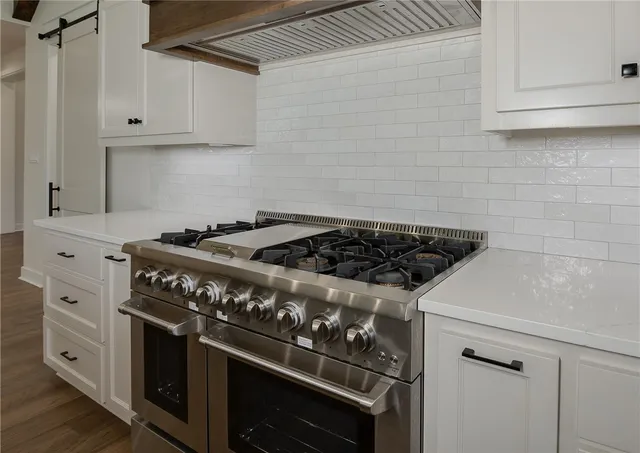 a white stove top oven sitting inside of a kitchen