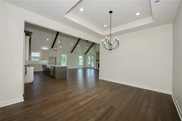 a view of a room with lots of wooden floor and sofas