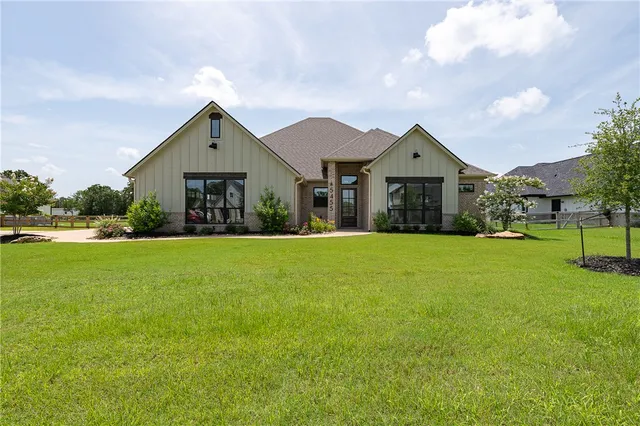 a front view of house with yard and green space