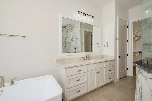 a bathroom with a granite countertop sink mirror and a