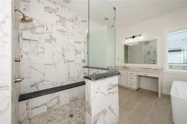 a bathroom with a granite countertop sink a toilet and shower