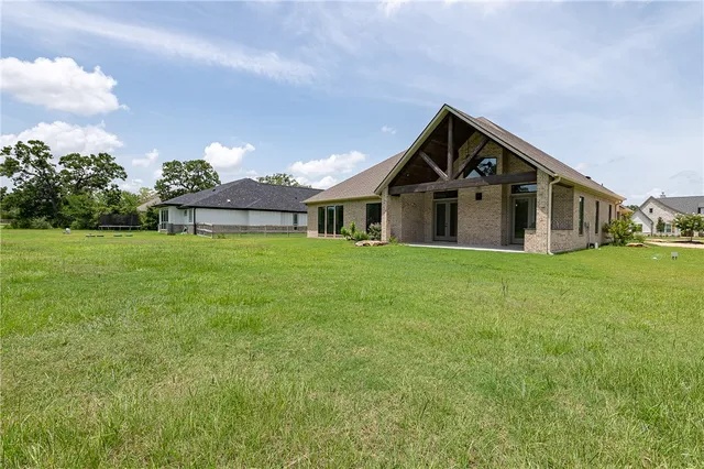 a front view of a house with yard and green space
