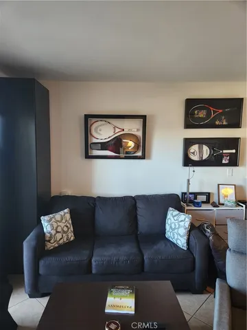 a living room with furniture and painting on the wall