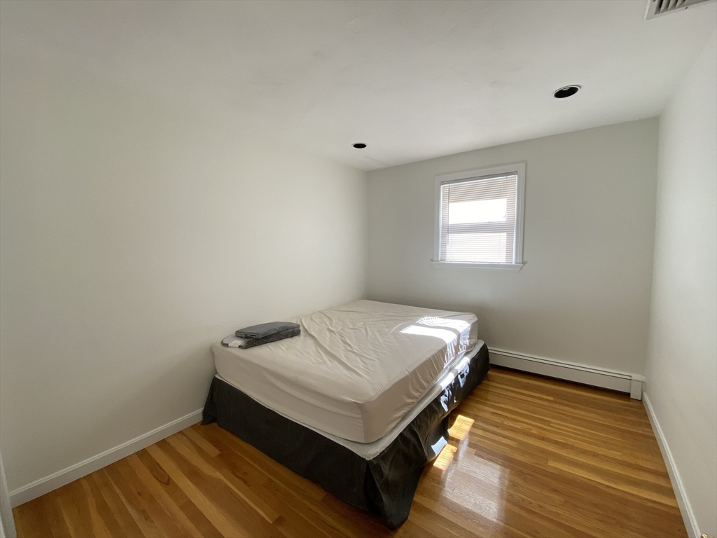 13 Oxbow Road Natick, MA 01760 - Photo 13 of 21 a bed sitting in a bedroom next to a window