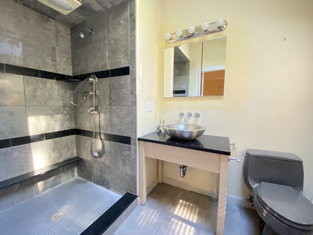 13 Oxbow Road Natick, MA 01760 - Photo 16 of 21 a bathroom with a sink a toilet and a mirror