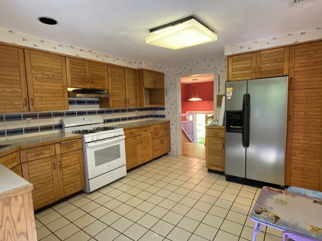 13 Oxbow Road Natick, MA 01760 - Photo 10 of 21 a kitchen with stainless steel appliances granite countertop a stove a sink and a refrigerator
