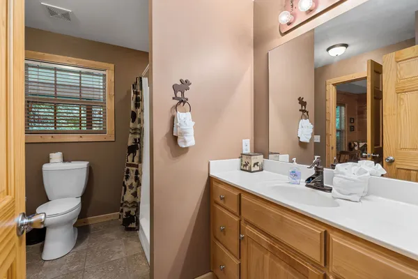 a bathroom with a shower curtain and a sink
