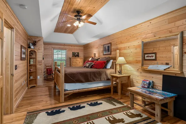 a bedroom with a bed and wooden floor
