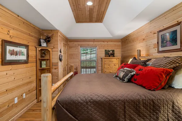 a bedroom with furniture and a rug