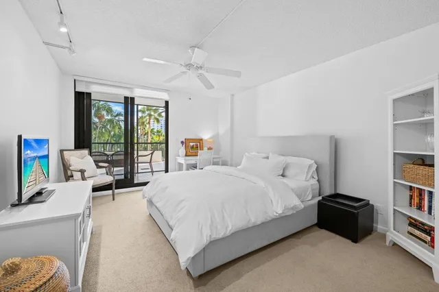 a bedroom with a bed dresser and a flat screen tv