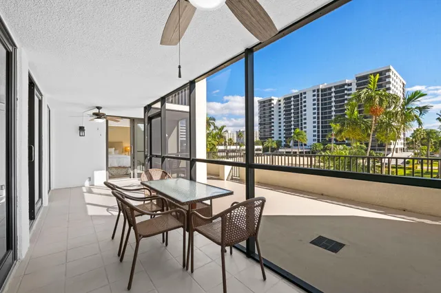 a view of a balcony with chairs and furniture