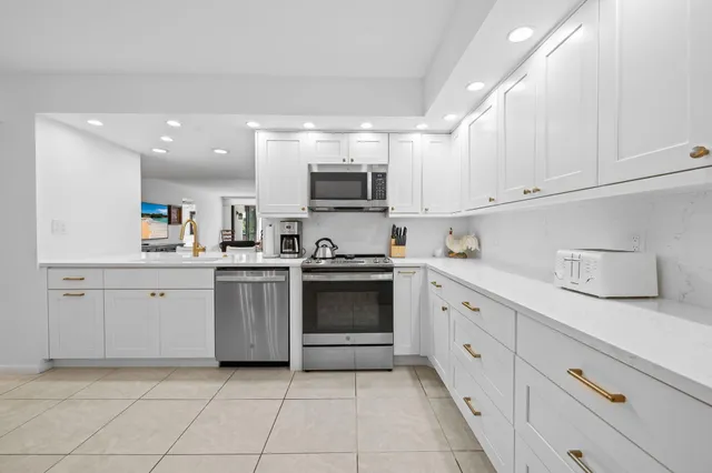 a kitchen with cabinets and appliances