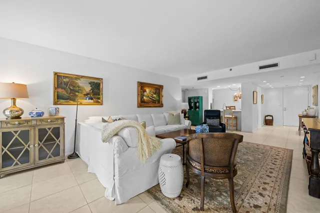 a living room with furniture a rug and white walls
