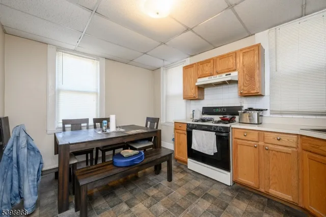 a kitchen with a stove a sink and a window