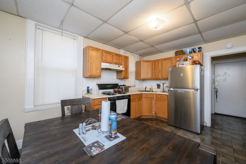 427 North 12th Street Newark, NJ 07107 - Photo 14 of 50 a kitchen with stainless steel appliances granite countertop a refrigerator a sink dishwasher a stove with wooden cabinets