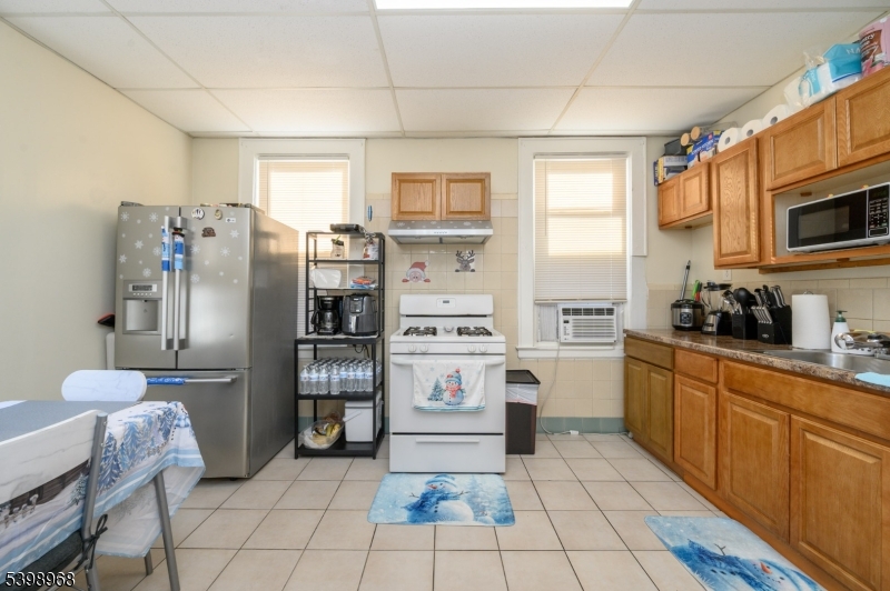 427 North 12th Street Newark, NJ 07107 - Photo 21 of 50 a kitchen with stainless steel appliances granite countertop a refrigerator and a stove top oven