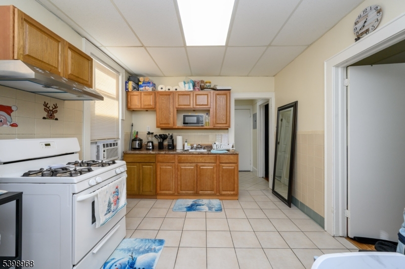 427 North 12th Street Newark, NJ 07107 - Photo 22 of 50 a kitchen with stainless steel appliances granite countertop a stove a sink and a refrigerator