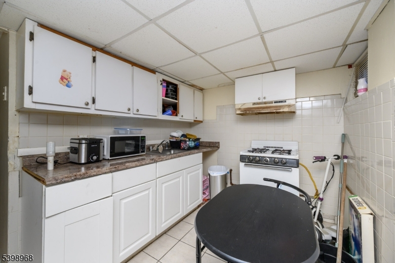 427 North 12th Street Newark, NJ 07107 - Photo 36 of 50 a kitchen with stainless steel appliances granite countertop a sink stove and cabinets