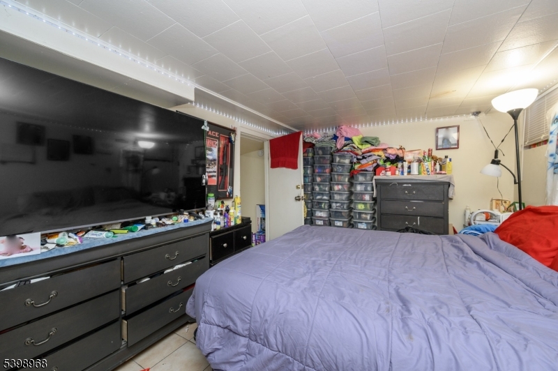 427 North 12th Street Newark, NJ 07107 - Photo 39 of 50 a bedroom with a bed and a flat screen tv