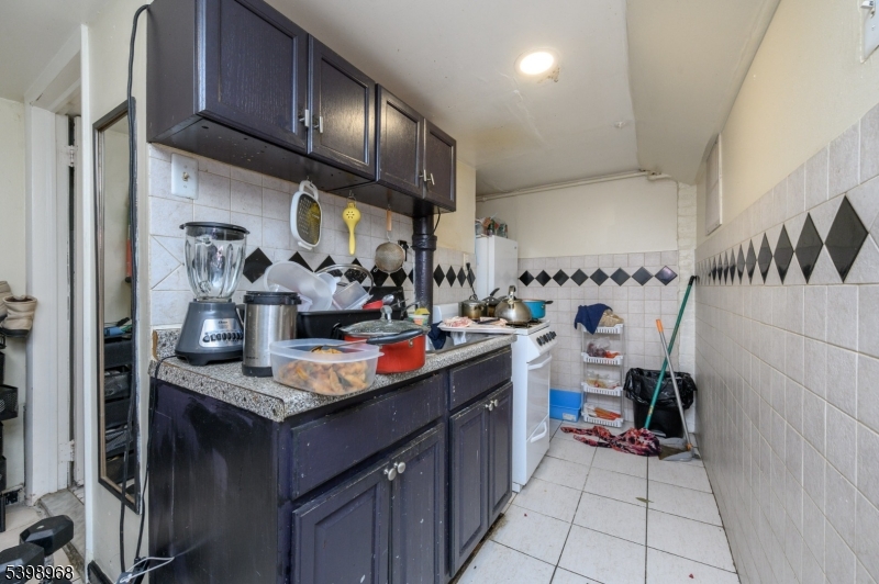 427 North 12th Street Newark, NJ 07107 - Photo 42 of 50 a kitchen with stainless steel appliances granite countertop a sink stove and cabinets