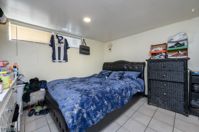 427 North 12th Street Newark, NJ 07107 - Photo 43 of 50 a bedroom with a bed and cabinets
