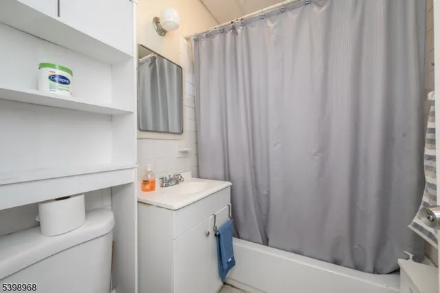 a bathroom with a sink and a shower curtain