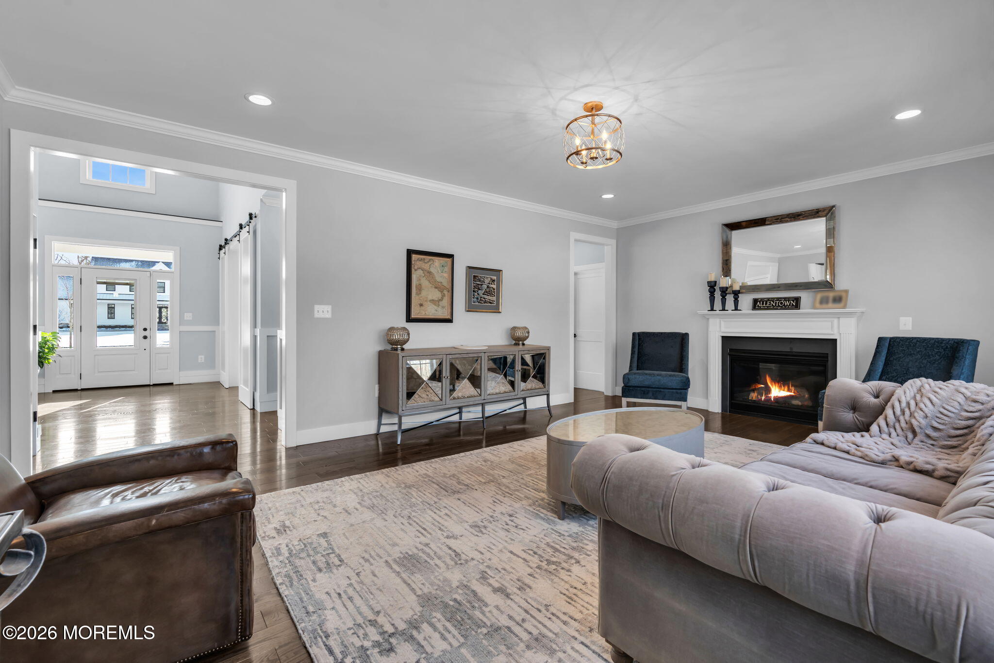 2 Tiffany Court Farmingdale, NJ 07727 - Photo 16 of 67 a living room with furniture a chandelier and a fireplace