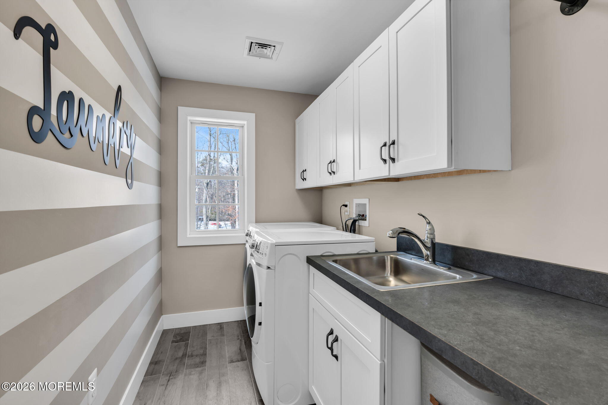 2 Tiffany Court Farmingdale, NJ 07727 - Photo 44 of 67 a kitchen with stainless steel appliances granite countertop a sink and a white cabinets with wooden floor