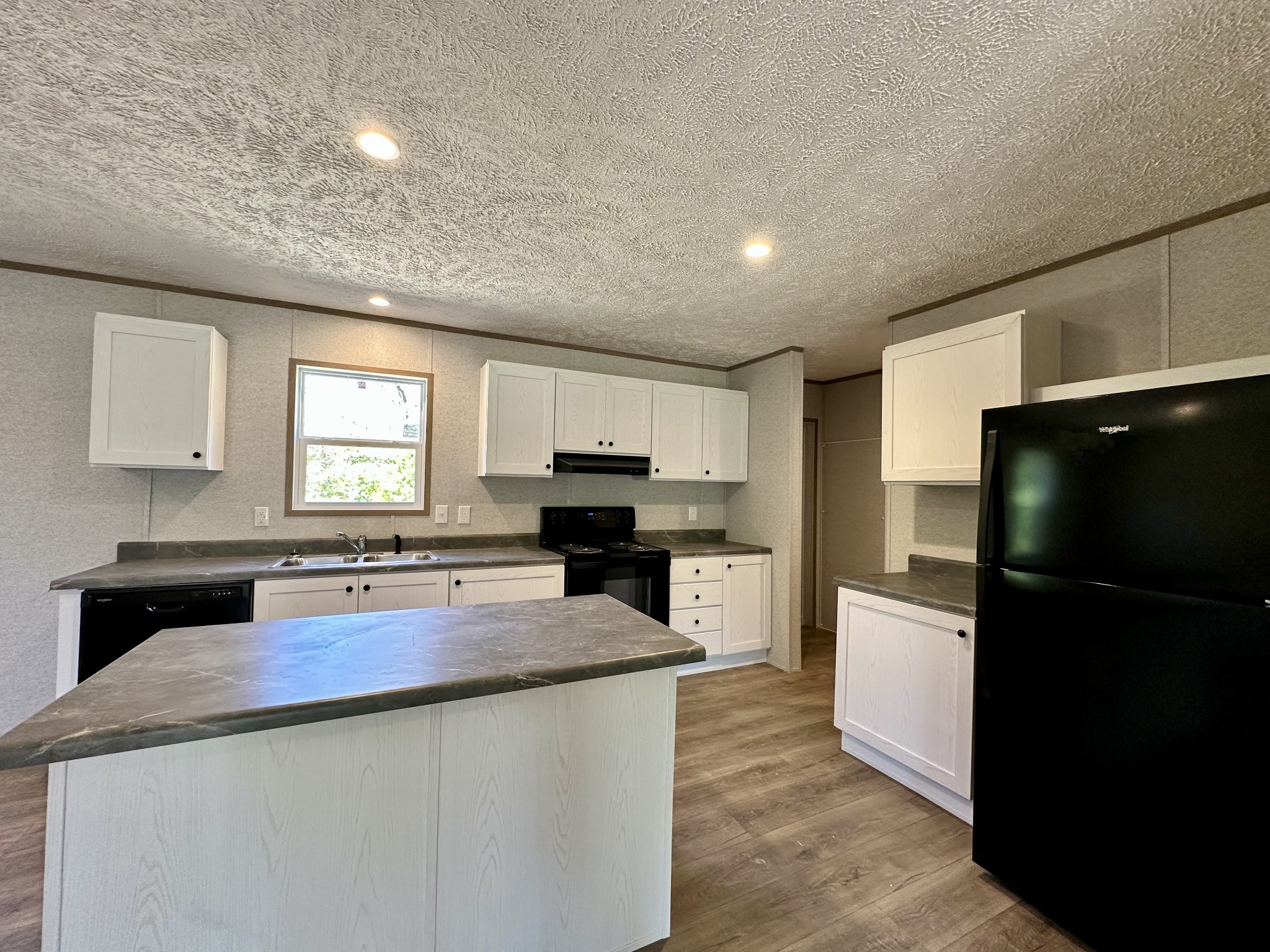 1739 Fairfield Road Westmoreland, TN 37186 - Photo 21 of 28 a kitchen with sink a refrigerator and cabinets