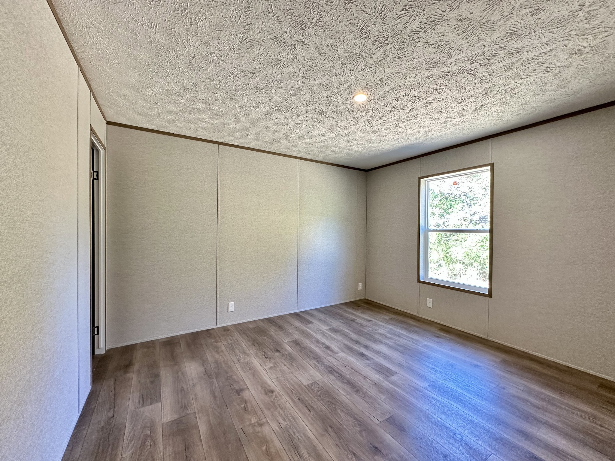 1739 Fairfield Road Westmoreland, TN 37186 - Photo 27 of 28 an empty room with wooden floor and windows
