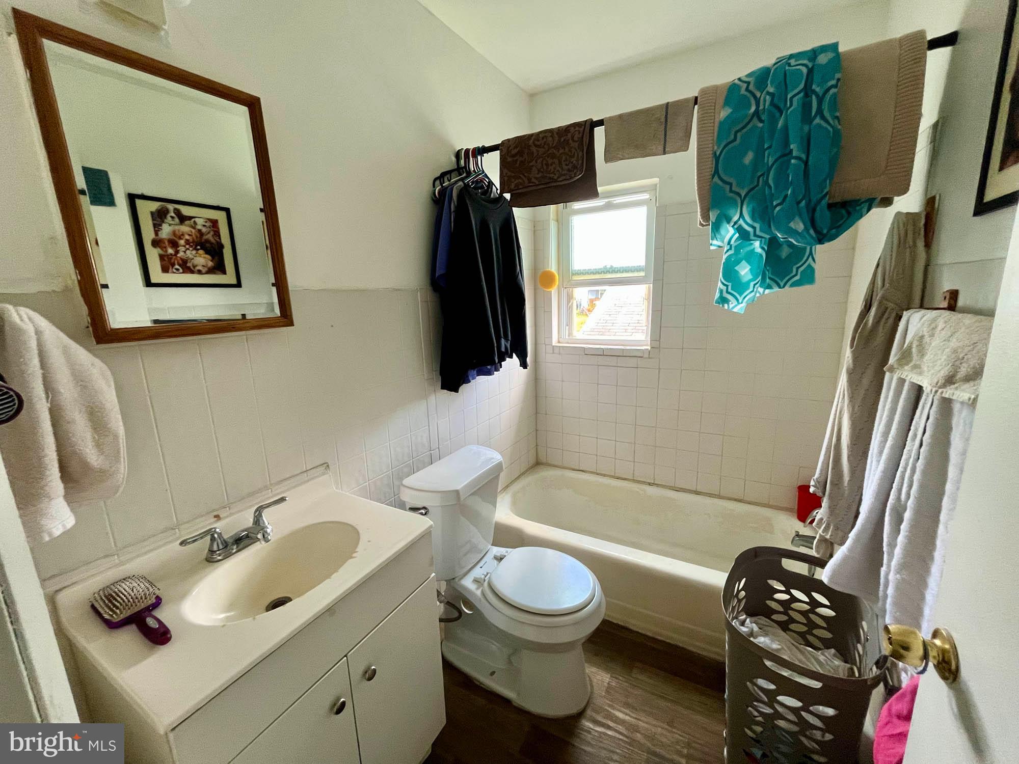 1725 Earhart Road Baltimore, MD 21221 - Photo 23 of 48 a bathroom with a sink toilet and shower