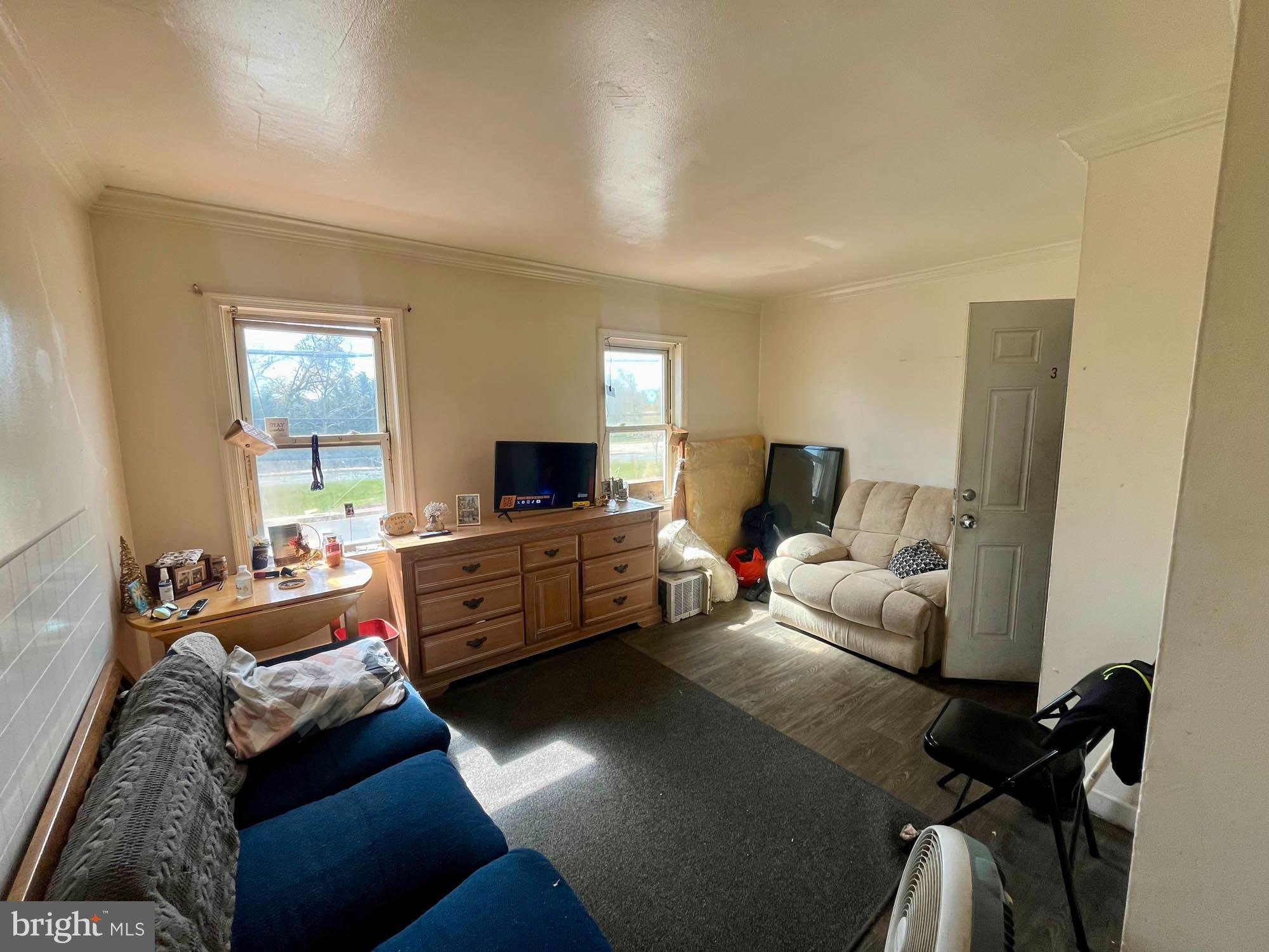 1725 Earhart Road Baltimore, MD 21221 - Photo 25 of 48 a bedroom with furniture and a flat screen tv