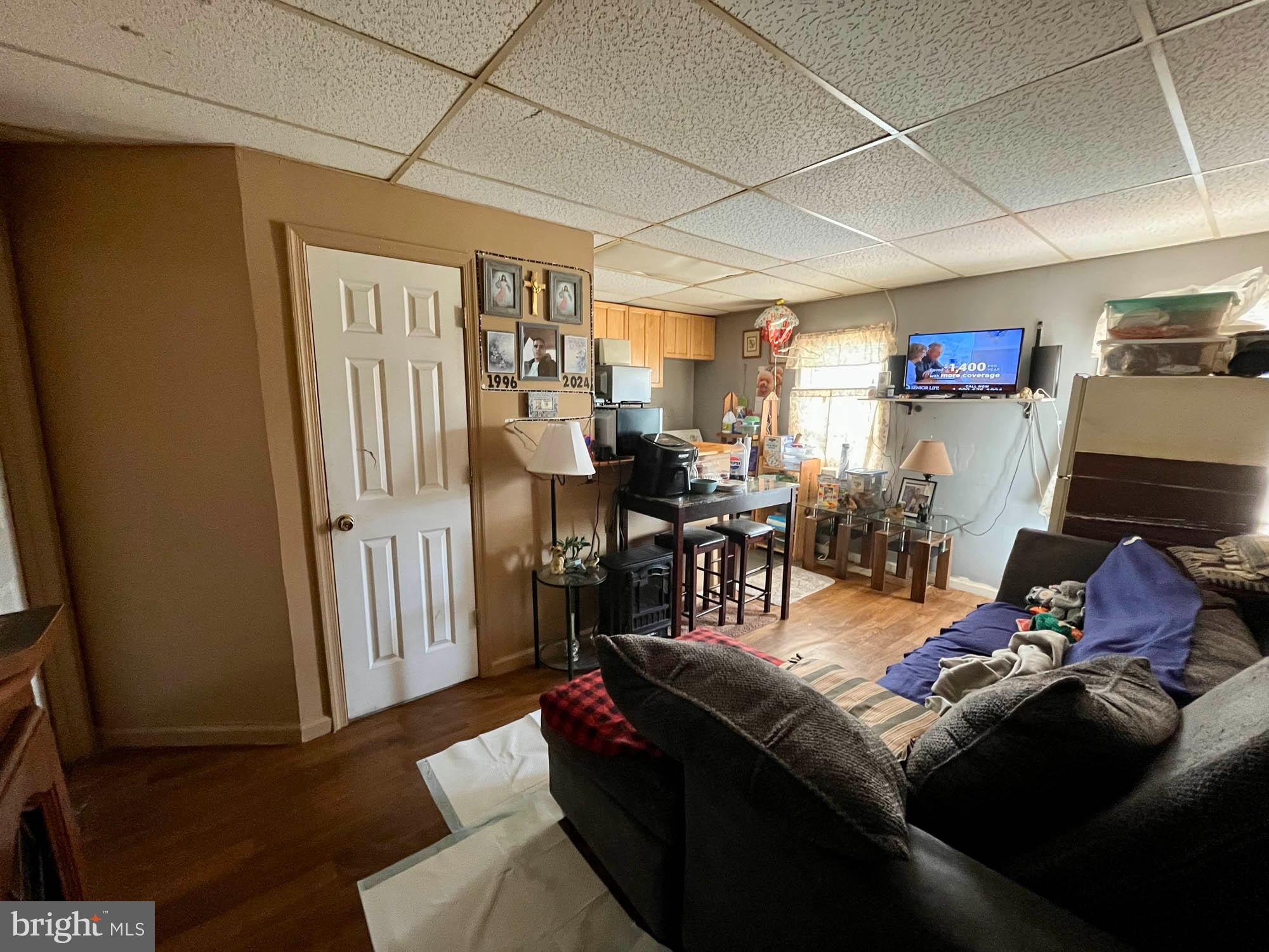 1725 Earhart Road Baltimore, MD 21221 - Photo 31 of 48 a living room with furniture and a flat screen tv