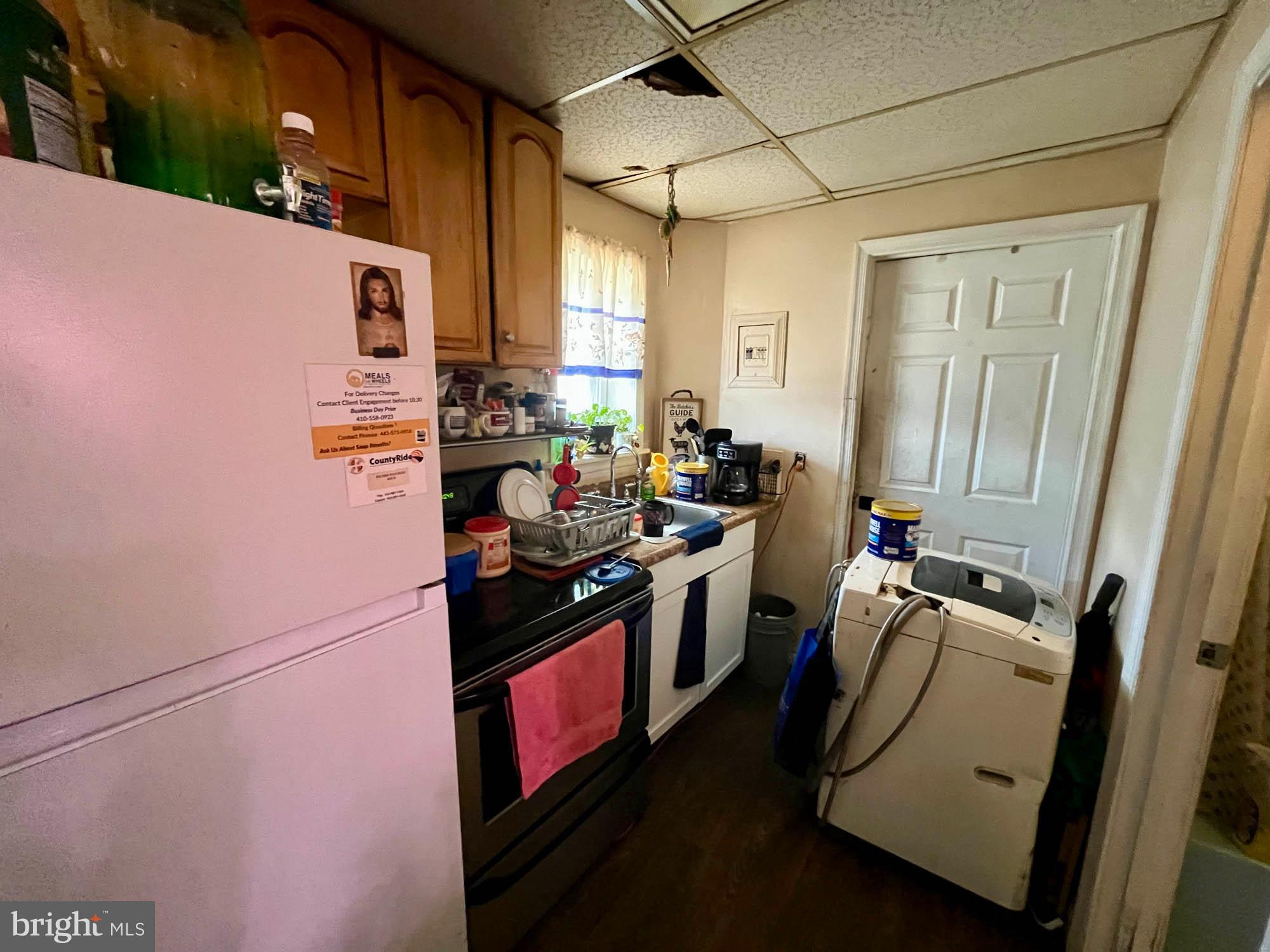 1725 Earhart Road Baltimore, MD 21221 - Photo 36 of 48 a kitchen with a refrigerator and a stove