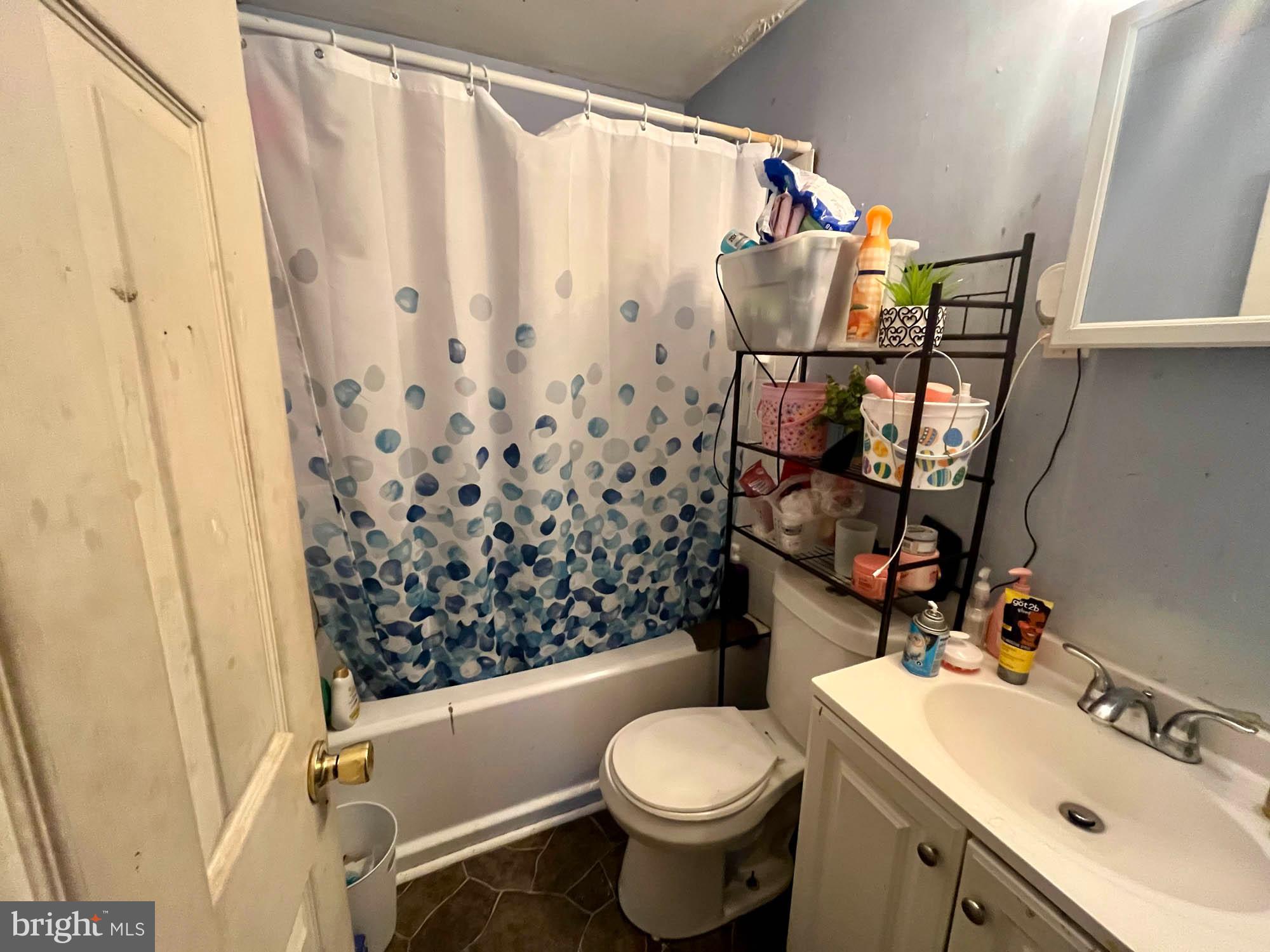 1725 Earhart Road Baltimore, MD 21221 - Photo 9 of 48 a bathroom with a sink toilet and shower