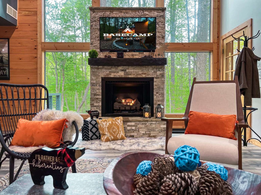 7 Addle Court Ellijay, GA 30540 - Photo 3 of 20 a living room with furniture a fireplace and a floor to ceiling window