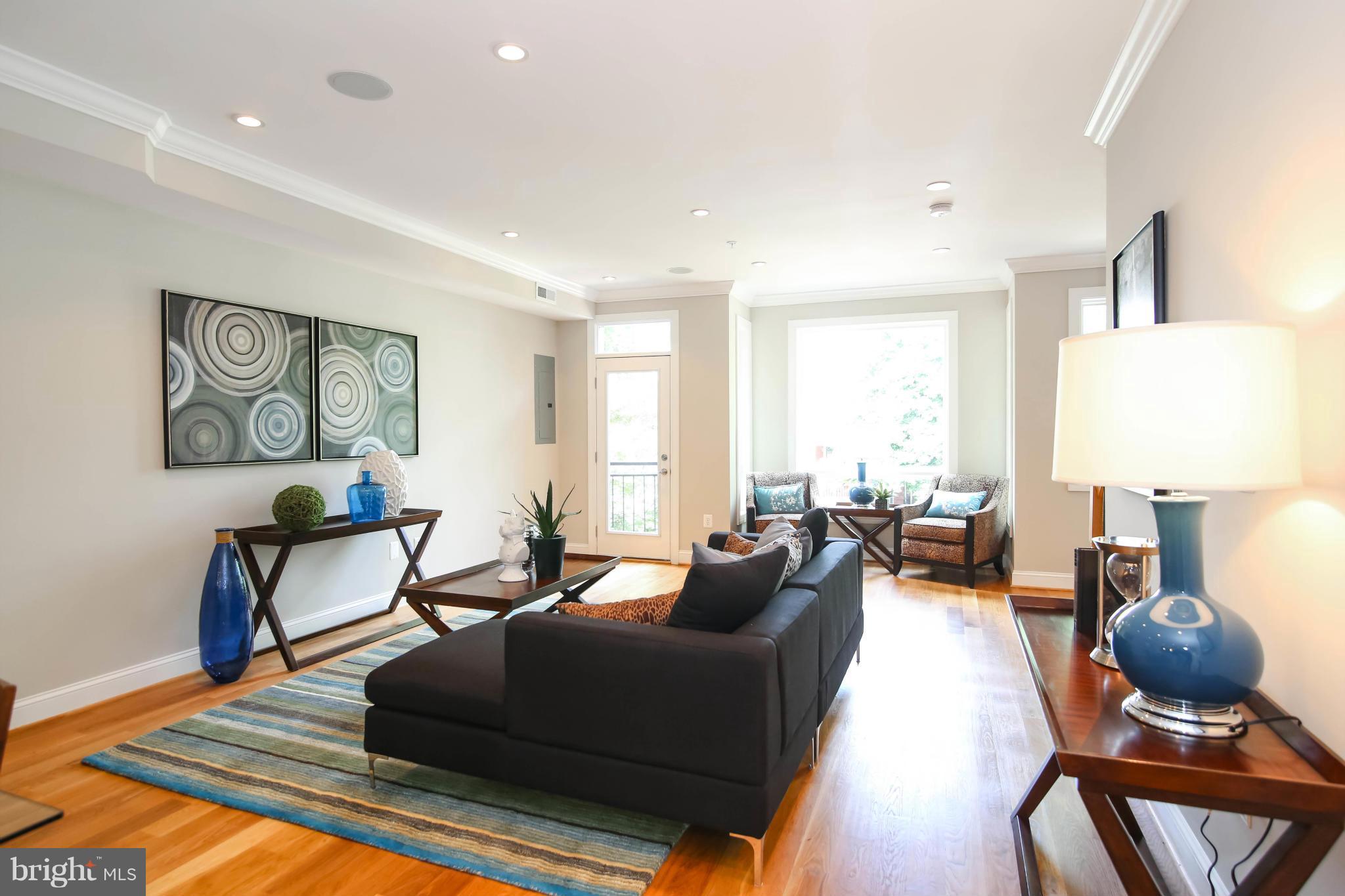 1131 5th Street Northeast, Unit 2 Washington, DC 20002 - Photo 2 of 27 a living room with furniture and a lamp