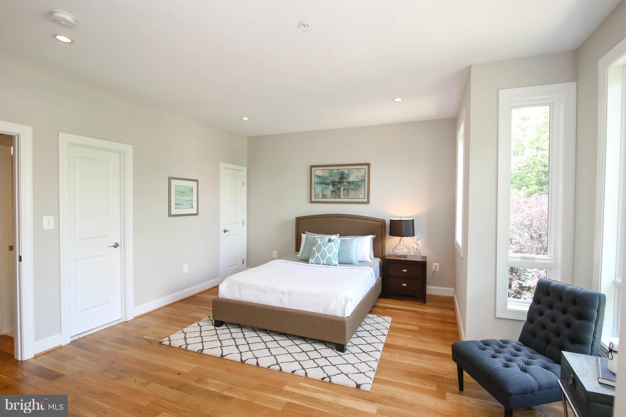 1131 5th Street Northeast, Unit 2 Washington, DC 20002 - Photo 14 of 27 a bedroom with a large bed and a couch