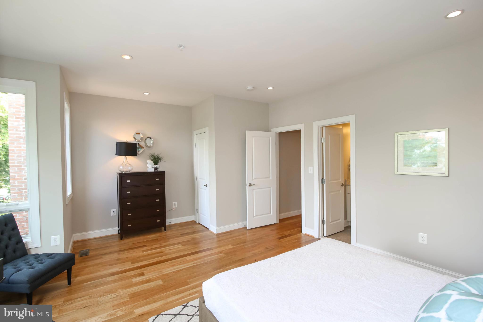 1131 5th Street Northeast, Unit 2 Washington, DC 20002 - Photo 15 of 27 a bedroom with a bed and wooden floor