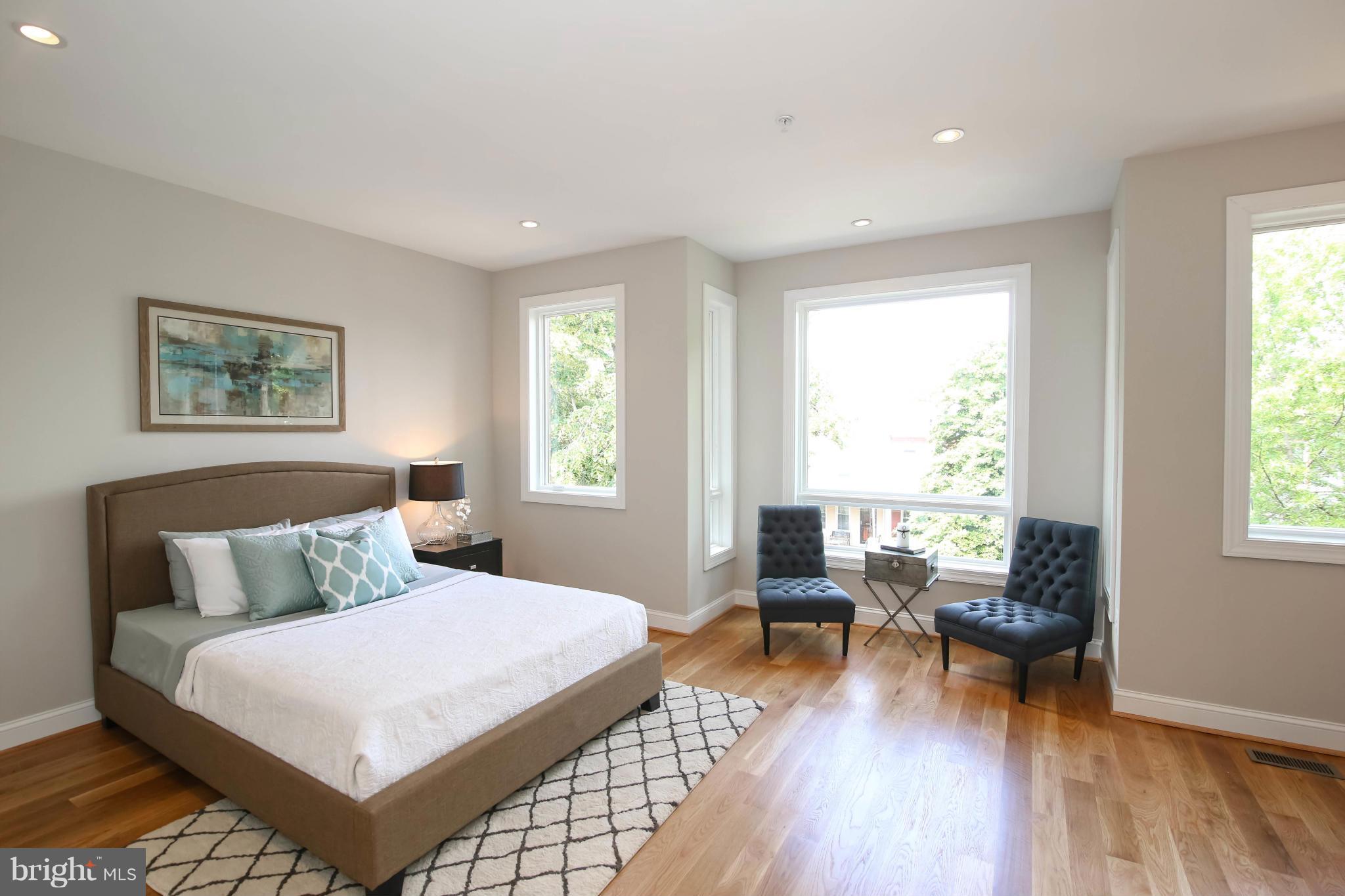 1131 5th Street Northeast, Unit 2 Washington, DC 20002 - Photo 16 of 27 a bedroom with a bed and wooden floor