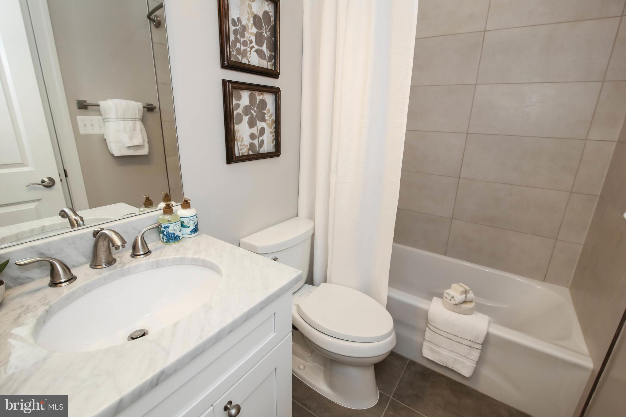 1131 5th Street Northeast, Unit 2 Washington, DC 20002 - Photo 17 of 27 a bathroom with a sink a toilet and shower