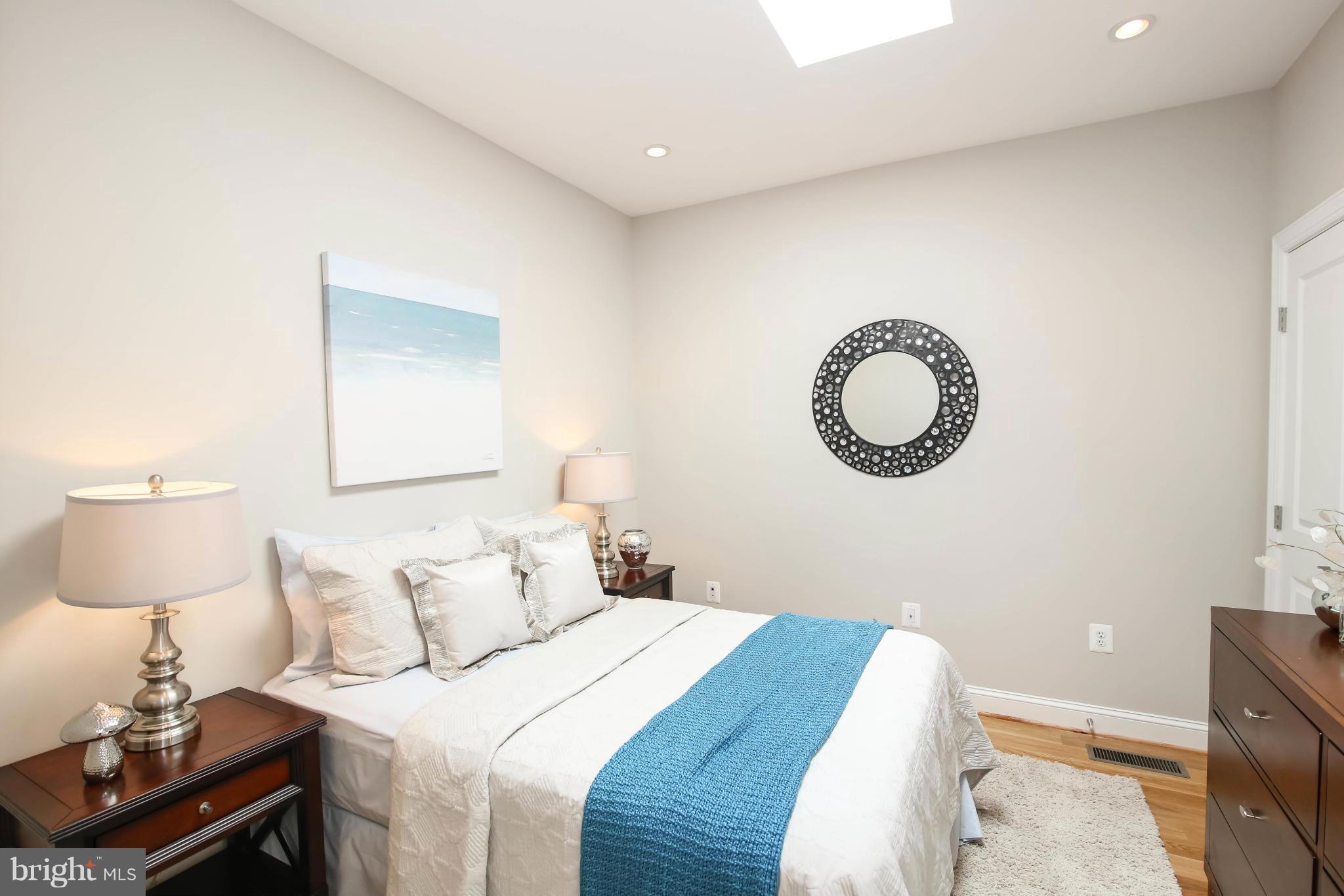 1131 5th Street Northeast, Unit 2 Washington, DC 20002 - Photo 18 of 27 a bedroom with a bed and a lamp